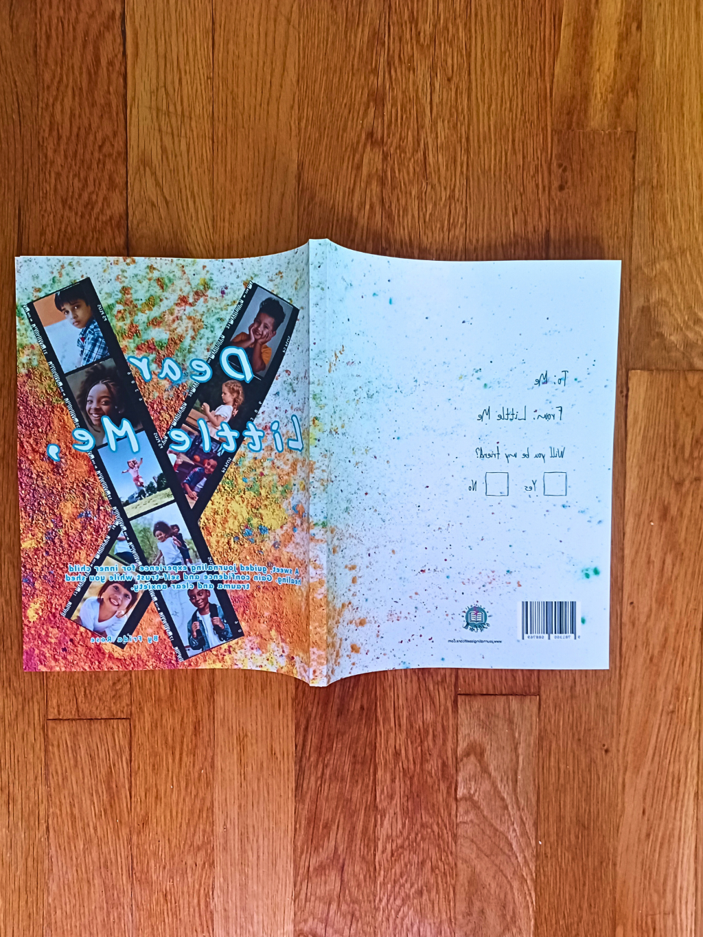 Open self discovery journal with colorful design and text on a wooden surface