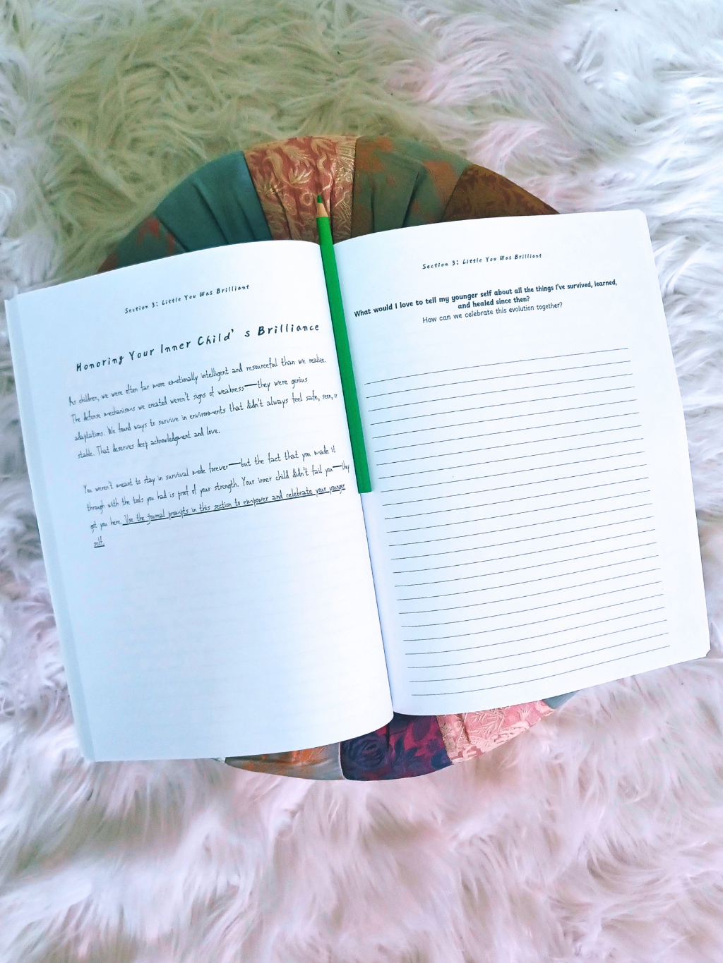 guided journal with childhood trauma writing prompts on a fluffy white surface
