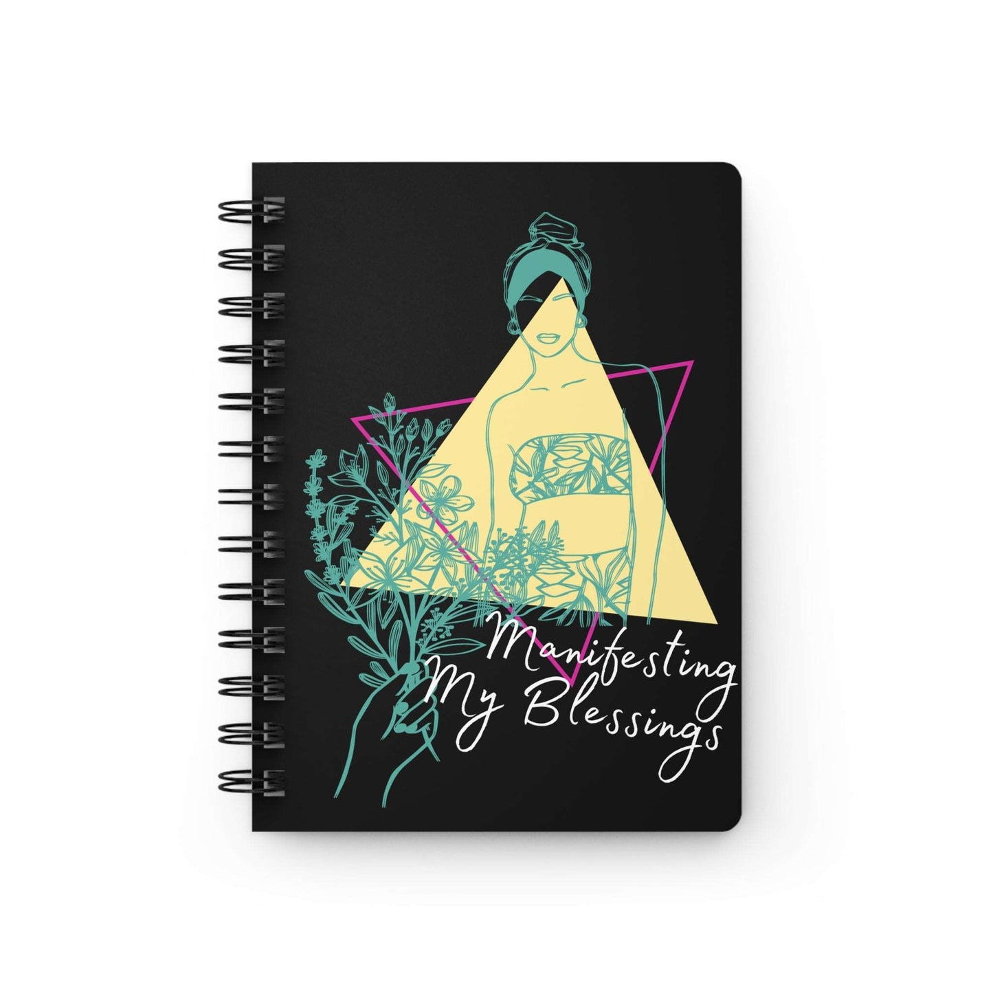 A spiral notebook with the words 'Manifesting My Blessings' on it, serving as an affirmation journal for magnifying my blessings through the law of attraction.