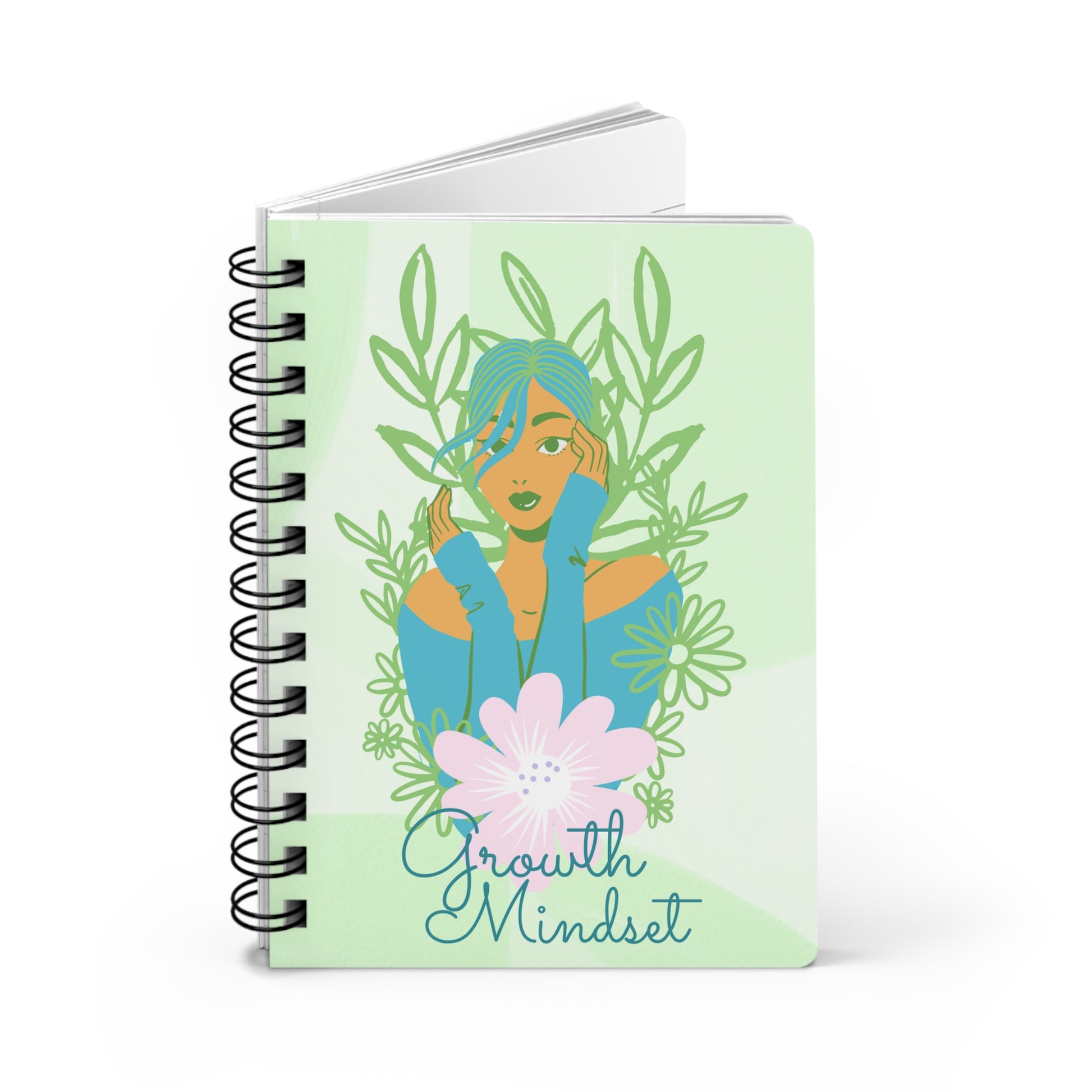 A green spiral notebook with the words "Growth Mindset" Inspirational Journal for Success and Self Improvement on it, serving as a reflective journal for emotional intelligence and growth mindset.