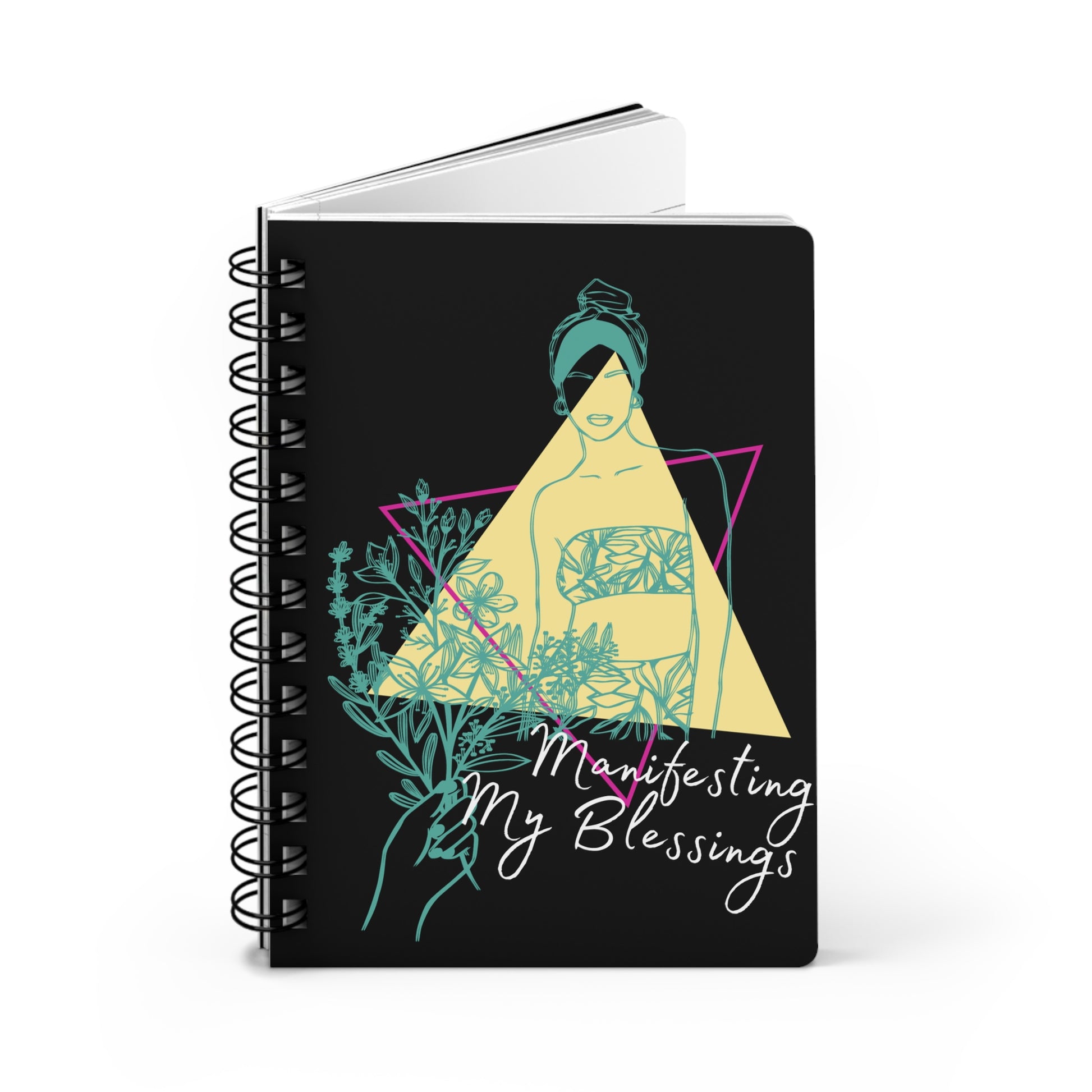 An "Manifesting My Blessings" Daily Affirmation Journal with the words "Meditate my blessings" on a black spiral notebook.