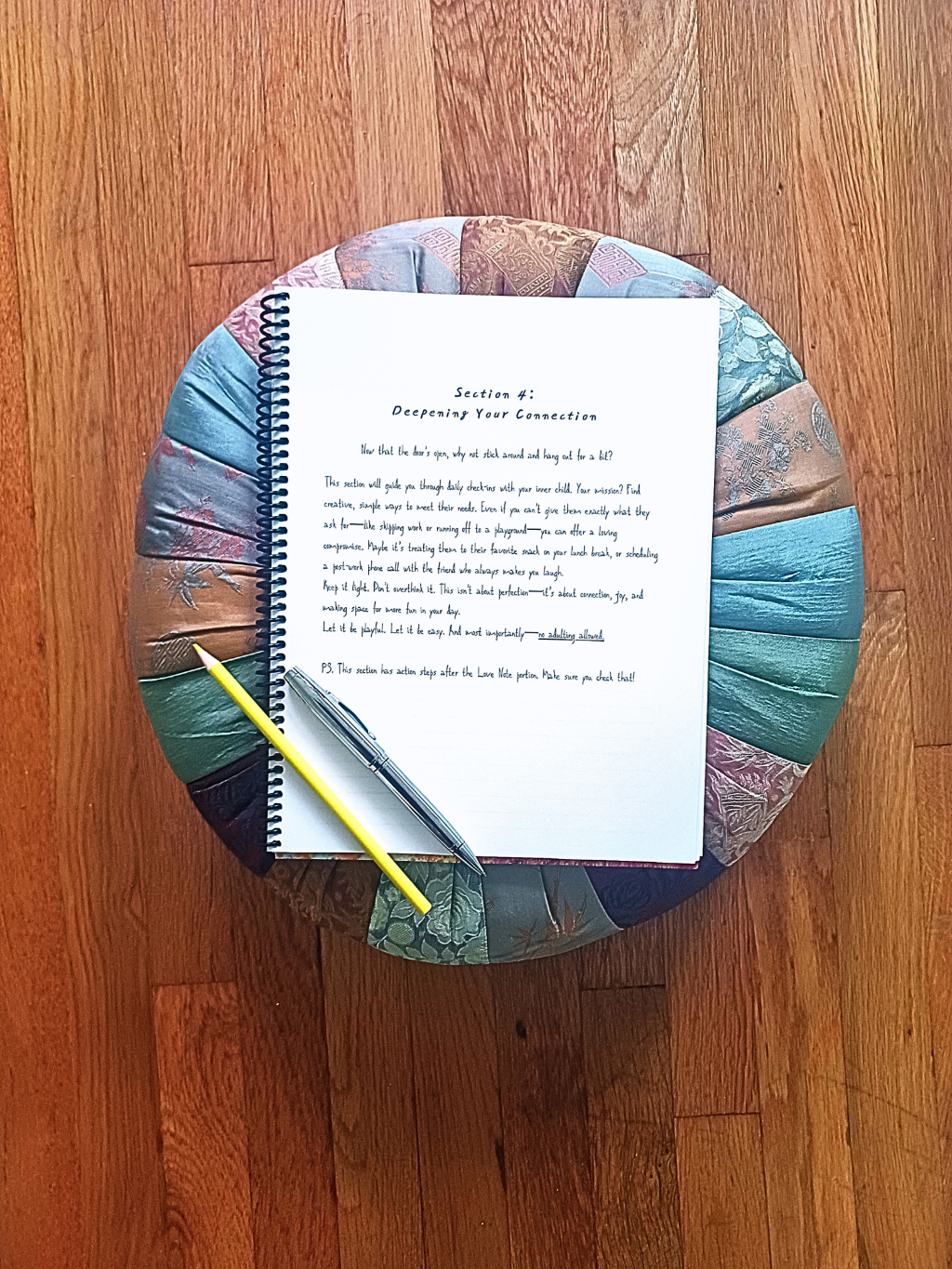 childhood trauma journal atop a colorful pillow on a wooden surface