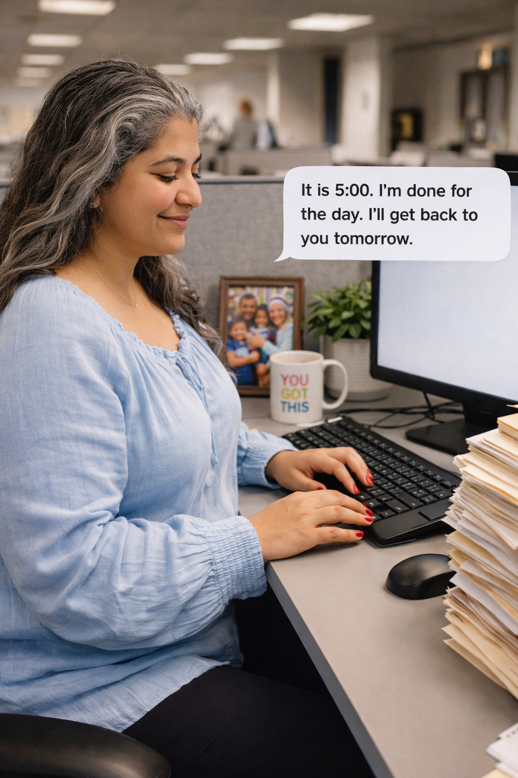 Woman at a desk with a computer, text bubble indicating she is done for the day. She sets boundaries.