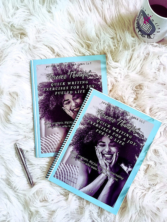 Two books titled 'Forever Thankful' on a fluffy white surface with a mug in the background.