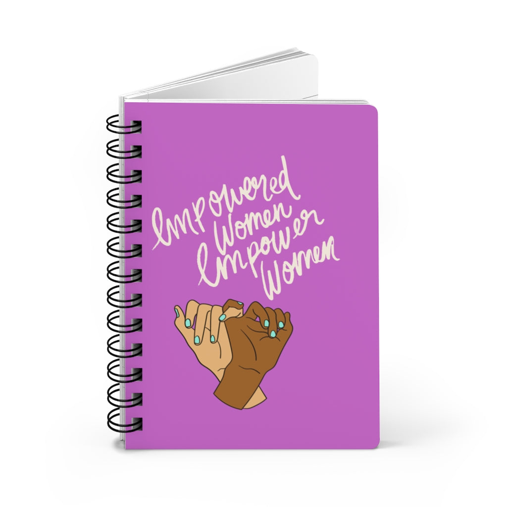 A purple spiral notebook with the words "Empowered Women Empower Women" Women's Empowerment Journal, perfect for women's empowerment and self-love practices.